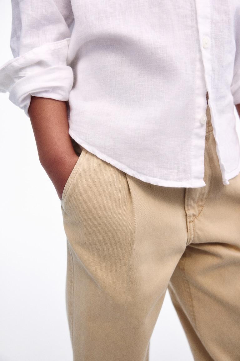 H&M Loose-fit tapered twill chinos Weihnachtsangebot