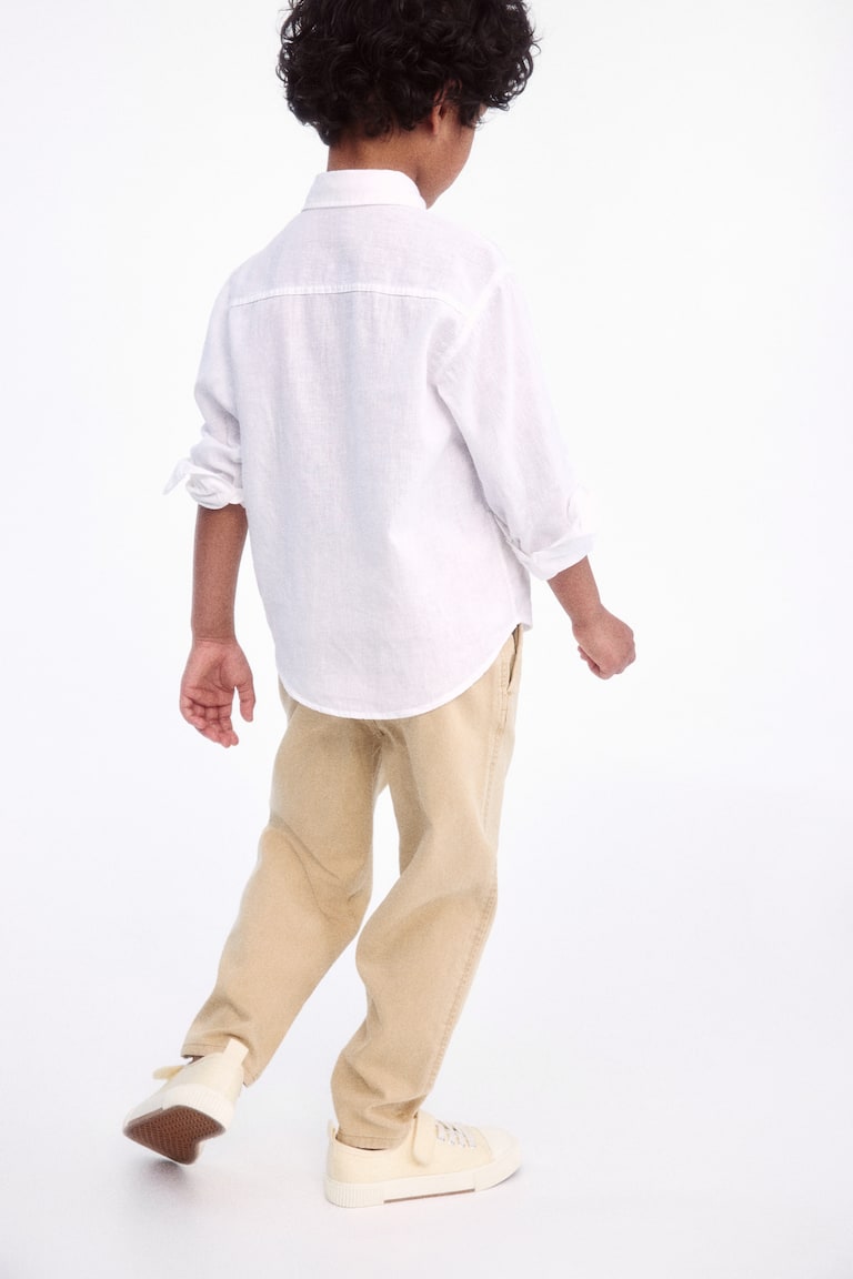 H&M Loose-fit tapered twill chinos Weihnachtsangebot